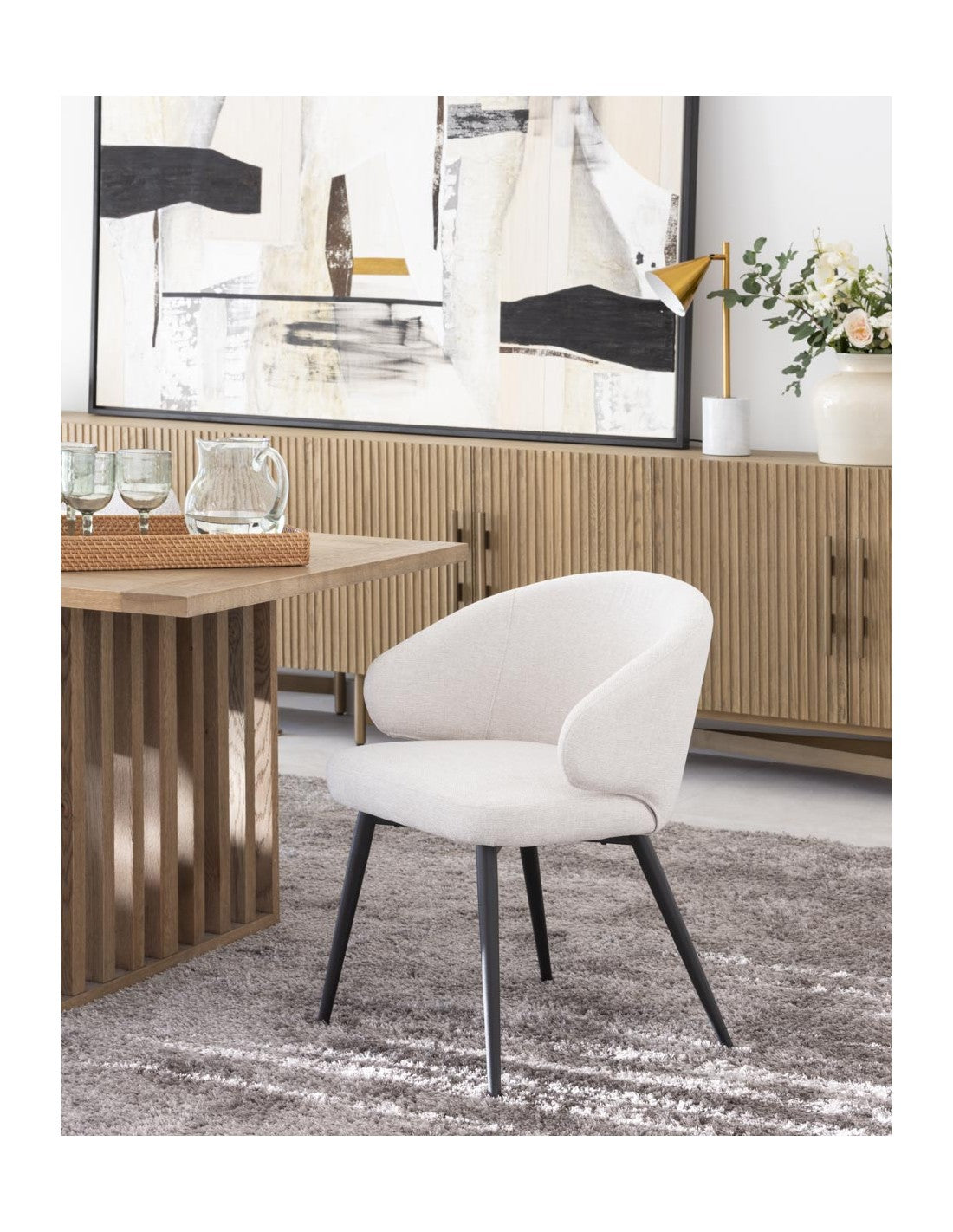 Sand-colored upholstered chair with black metal legs