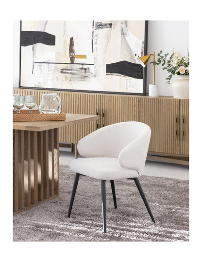 Sand-colored upholstered chair with black metal legs
