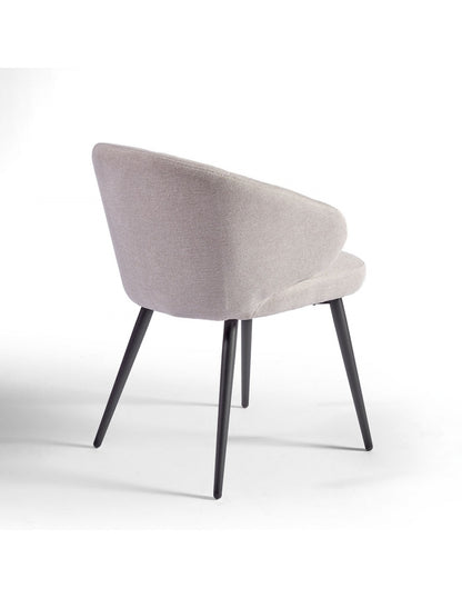 Sand-colored upholstered chair with black metal legs