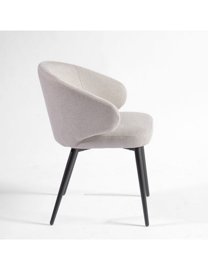 Sand-colored upholstered chair with black metal legs