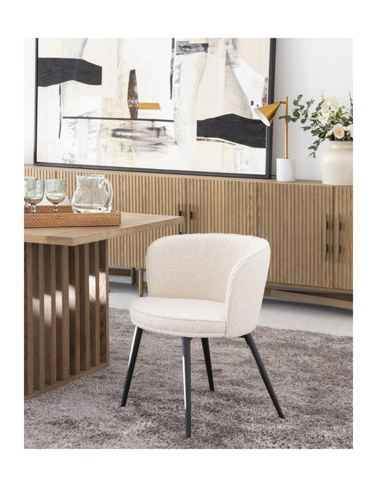 Rounded sand and black metal upholstered chair